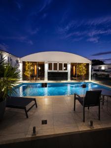 a swimming pool in a building at night at ibis Styles Broken Hill in Broken Hill