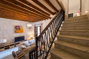 a staircase in a living room with a couch and a tv at Villa Ca na Marrona - Sunset Villa Campanile in Sa Pobla