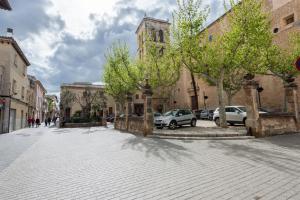 a cobblestone street in a city with cars parked at Villa Ca na Marrona - Sunset Villa Campanile in Sa Pobla