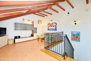 a living room with a staircase and a flat screen tv at Hedera Estate Hedera A34 in Dubrovnik