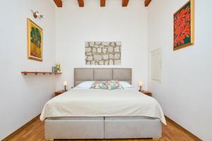 a bedroom with a bed and paintings on the wall at Hedera Estate Hedera A34 in Dubrovnik