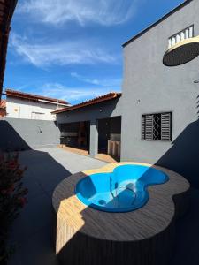 a house with a blue pool in front of a building at Paraíso Oculto in Carolina