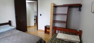 a bedroom with a bed and a stair case at 001 1 Dormitorio Centro Bombinhas 400 m da praia in Bombinhas