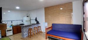 a kitchen with a blue couch in a room at 001 1 Dormitorio Centro Bombinhas 400 m da praia in Bombinhas +17 photos