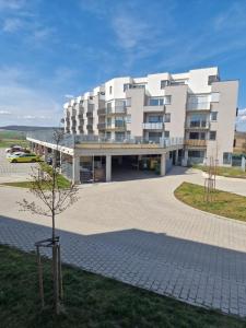 a large white building with a tree in front of it at Luxusní GLAM apartmán u Brna - Vana, Terasa, Nebesa, Parkování zdarma in Bučovice