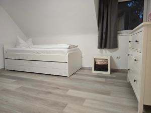 a bedroom with a bed and a dresser at Green House in Haibach
