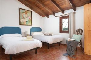 two beds and a chair in a room at Sunset private Eco-Villa Can Vey in Inca +59 photos