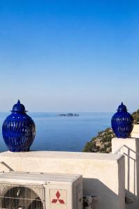 two blue vases sitting on top of a wall at Love in Blue - La Terrazza di Positano in Positano