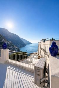 a view of the ocean from a balcony of a building at Love in Blue - La Terrazza di Positano in Positano