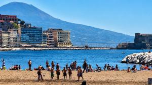 a group of people on a beach near the water at Lo Studio della Riviera in Naples