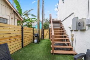 a stairway leading up to a house with a fence at Ocean Retreat C in Boynton Beach