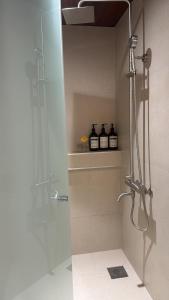 a bathroom with a shower with two bottles on a shelf at Maison de Clare 메종드클레어 in Gyeongju