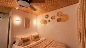 a bedroom with a bed with a ceiling at Solenta trace 01 in El Nido
