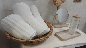 a basket of towels on a bathroom counter with a mirror at "Da Zia House Comfort e Relax vicino a Torino" in Brandizzo +51 photos