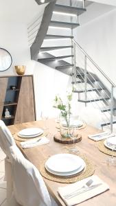 a dining room table with white plates and silverware at "Da Zia House Comfort e Relax vicino a Torino" in Brandizzo