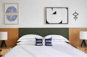 a bedroom with a large white bed with two lamps at Kimpton Hotel Enso by IHG in San Francisco