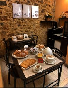 a table with bread and pastries on it at Collina Blu in Cuglieri