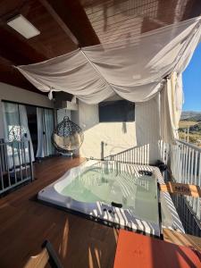 a deck with a hot tub on a house at Casa estadia Capitólio in Capitólio