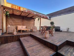 a wooden deck with a table and chairs at Maisons Sauvage 3 3 Bis in Romorantin