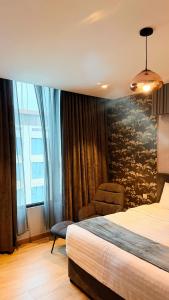 a hotel room with a bed and a chair at Millennium Private Apartment in Salalah
