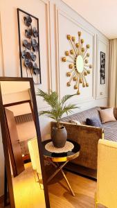 a living room with a table with a plant on it at Millennium Private Apartment in Salalah +18 photos