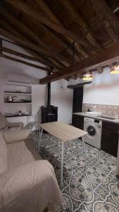 a living room with a table and a kitchen at Cuevas Padre Poveda in Guadix