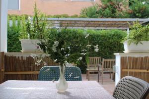 a vase with flowers in it sitting on a table at Residence Le Barchette in San Cataldo