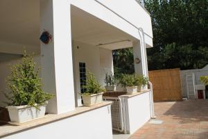 a porch with potted plants on the side of a house at Residence Le Barchette in San Cataldo