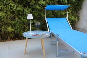 a bed and a table with a glass of wine at Residence Le Barchette in San Cataldo +91 photos