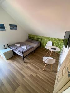a bedroom with a bed and a table and a chair at House Hostelli in Grzybowo +73 photos