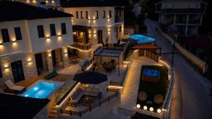 an aerial view of a building with a swimming pool at night at Aje Villas 1959 in Ioannina