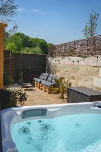 a jacuzzi tub in a yard with a patio at La Maison dAmbre-Jacuzzi-Sauna-Clim-4chambres in Saumur