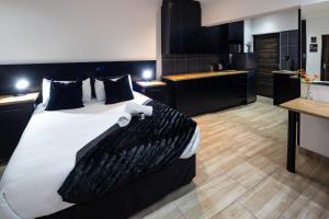 a large bedroom with a large bed and a kitchen at Fox Inn Guesthouse Lephalale in Lephalale