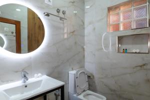 a bathroom with a sink and a toilet and a mirror at Fabiani Boutique Hotel Castle Gate in Krujë +61 photos
