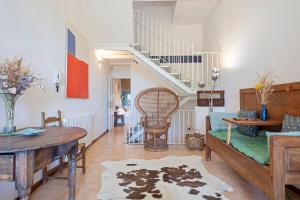 a living room with a table and a staircase at ¡Vistas al Castillo Casa con Piscina en el Centro in Peratallada