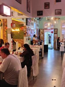 a group of people sitting at tables in a restaurant at Pousada e Restaurante Dona Siroba in Morretes +242 photos