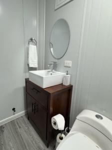a bathroom with a sink and a toilet and a mirror at Río Celeste Stay in Rio Celeste +32 photos