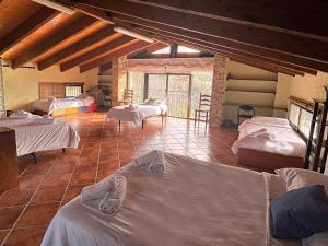 a room with several beds in a room with at Masía de piedra con piscina in Riudecols +41 photos