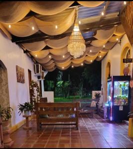 a pavilion with a bench and a chandelier at Pousada e Restaurante Dona Siroba in Morretes