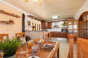 a kitchen and dining room with a table and chairs at Your Island Villa Son Serra in Son Serra de Marina