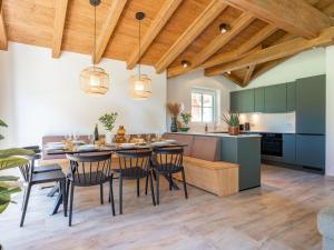 an open kitchen and dining room with a table and chairs at FIIF Pinzgau in Wald im Pinzgau +38 photos