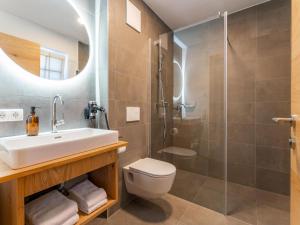 a bathroom with a sink toilet and a shower at FIIF Pinzgau in Wald im Pinzgau