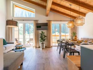 a living room with a long table and chairs at FIIF Pinzgau in Wald im Pinzgau