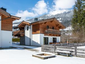 a house in the mountains with snow on the ground at Chalet Joep in Wald im Pinzgau