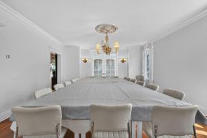 a large dining room with a large table and chairs at Private Waterfront Villa 9 BR Peaceful in Laval