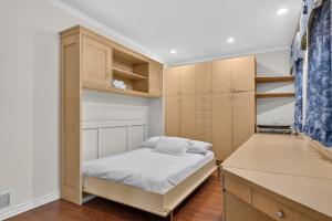 a small bedroom with a bed and cabinets at Private Waterfront Villa 9 BR Peaceful in Laval +29 photos