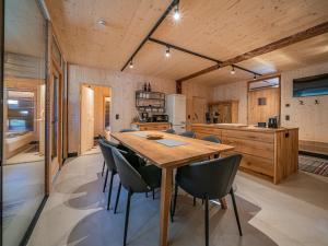 a kitchen and dining room with a wooden table and chairs at Raneburg 4 Futterhaus in Matrei in Osttirol
