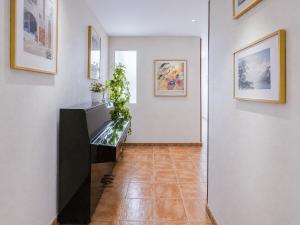 a hallway with a fish tank on a white wall at Sun Serramar Boutique Hostal in Benalmádena