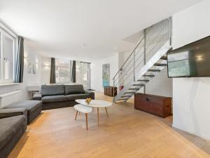 a living room with a couch and a table at t Loftje in Veurne