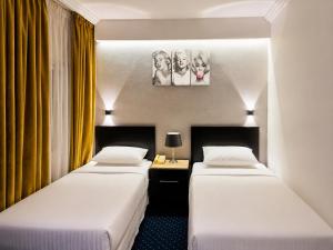 two beds in a hotel room with a painting on the wall at Private Luxury Villas at Sharm Dreams Vacation Club in Sharm El Sheikh +27 photos